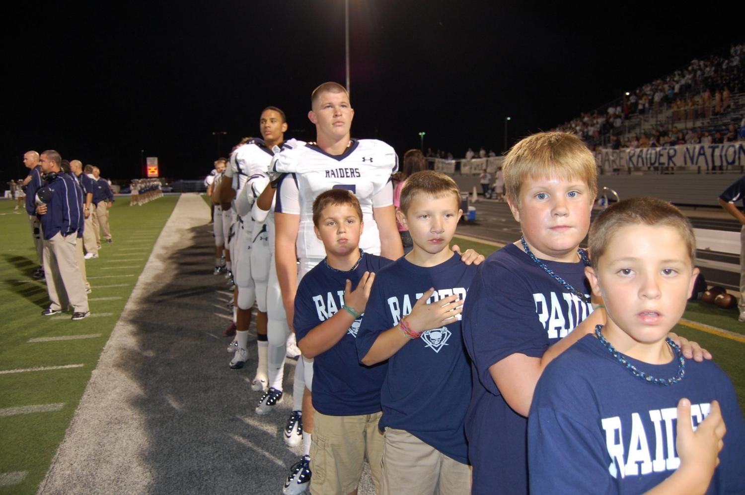 Raider for life // From the 2013 season, seniors Jesse Brubaker and Marcell Ateman stand behind ball boys Cooper Andrews, Tyler Lambert, Will McCune and Travis Lambert. The four ball boys are now students here.