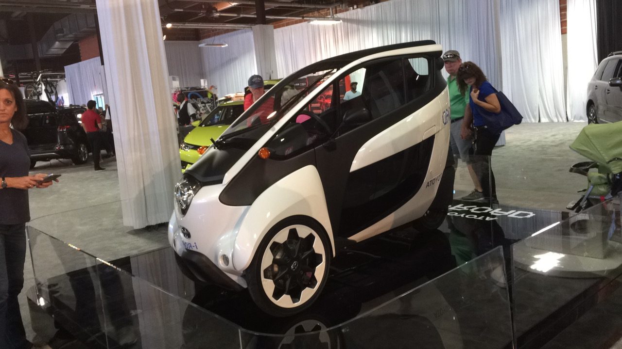 Toyota reveals one of its concept vehicles, the i-Road, a compact electric car designed for congested cities.