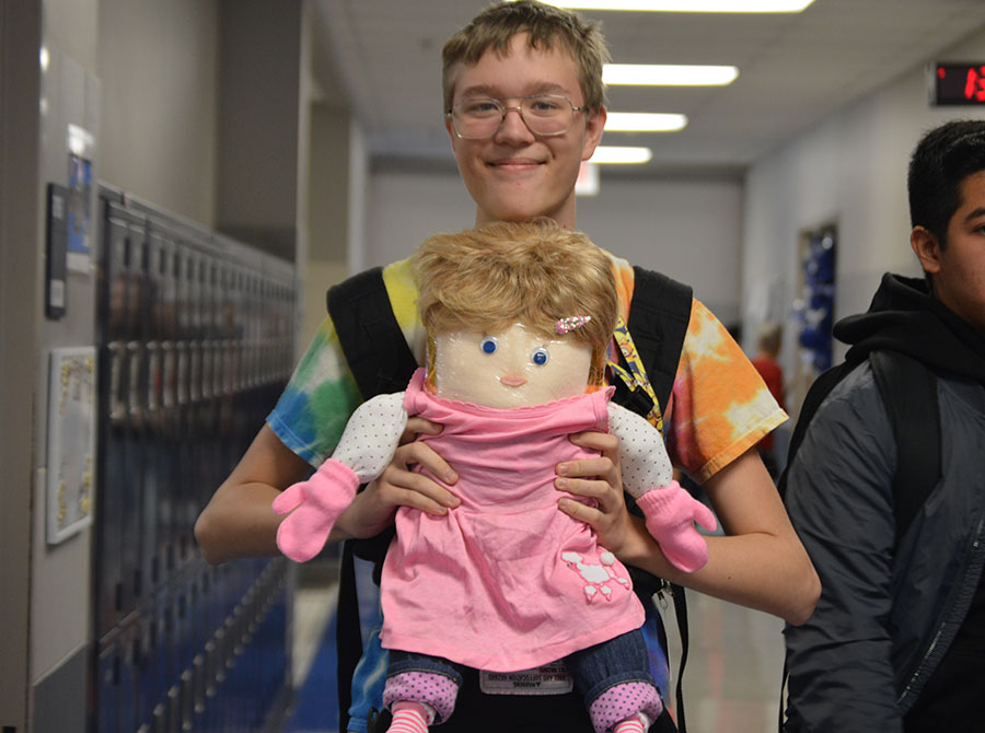 Dress up // Walking through the halls, sophomore Edward Shuster carries around his flour baby during homecoming week Oct. 19. “I named my baby Elenor because the name is like a female version for Edward,” Shuster said. Shuster dressed up his baby for each spirit day Oct. 18 - 20 for homecoming week.