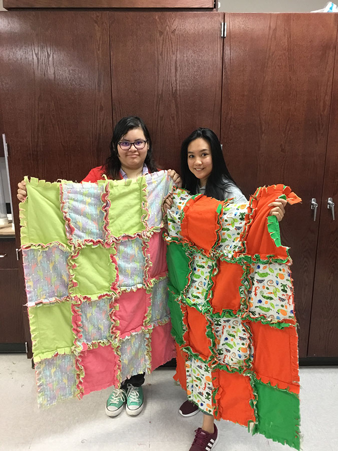 Quality quilts
Juniors Nikki Sabala and Isabel Mora show their hard work to the world. Fashion Club members made blankets to donate to The Children’s Advocacy Center.