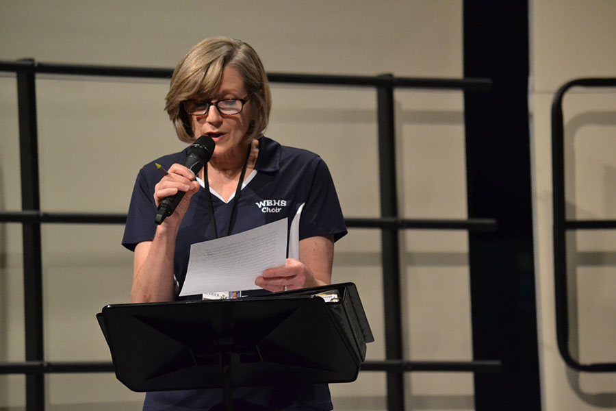 A sweet introduction // At the concert, Head Choir Director Mrs. Terry Berrier tells the audience what’s in store for the Pop Mashup concert Jan. 23. This year is Mrs. Berrier’s last year of teaching.