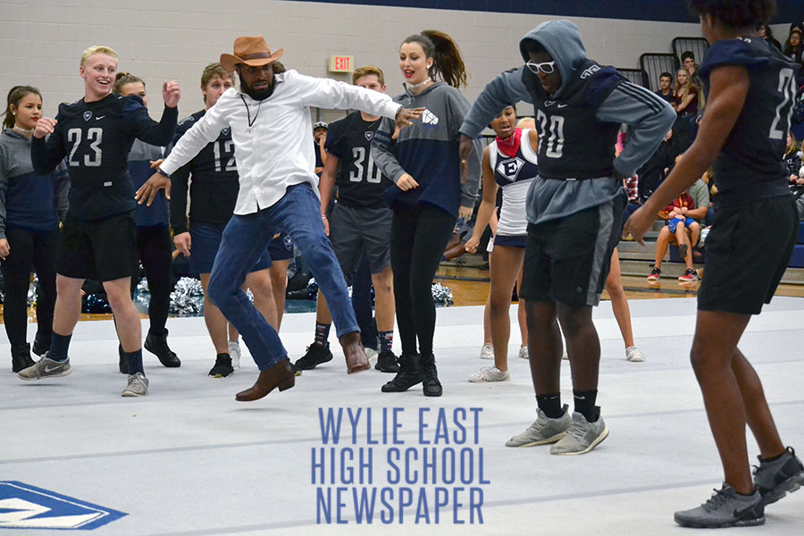 Cuttin a rug \\ Dressed in his western attire, stealing the show, psychology teacher Mr. Levi Turner dance battles other students at the dance off during the second pep rally of the year. The varsity football team was celebrated as they head off to play West Mesquite Sept. 27.
