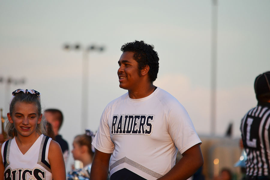 Cheering through hard times \\ Senior Zach Wilson smiles and chants for Raider Nation despite the hard times and responsibilities he has at home. 
photo by  Caroline Witty