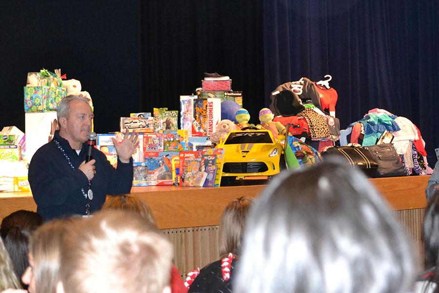 Gifts galore \\ Principal Mike Williams thanks the student body for the items they collected to help out local families in need.