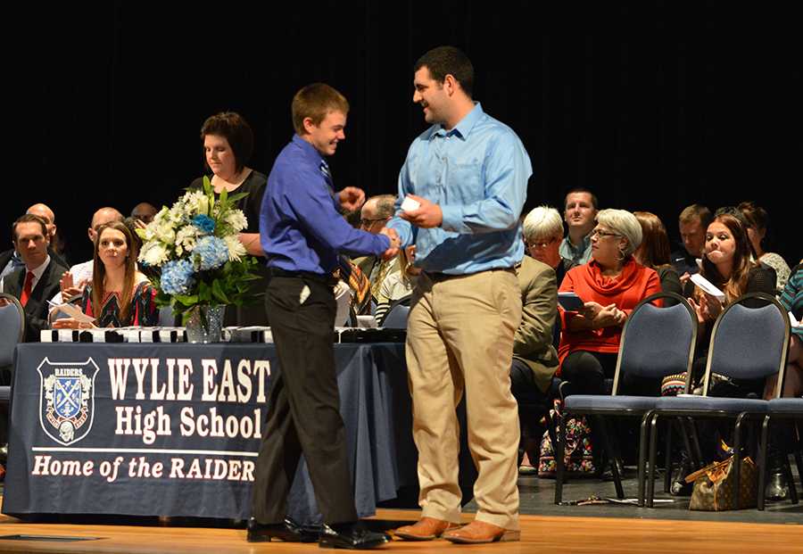 Nice ring to it \ Junior Holt Black asked Coach Joe Castleman to present him with his class ring. The annual ring ceremony took place Dec. 4 in the auditorium.