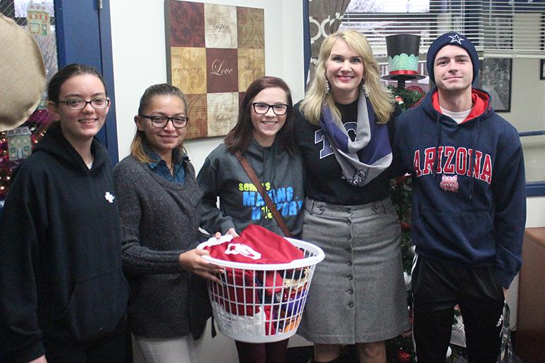 Helping hand \\ SKILLS USA law enforcement students donate t shirts to Hartman Elementary. Pictured from left to right are freshman Haley Proctor, senior Galilea Monterroso, senior Nicole Norenberg, Hartman Elementary Principal Mrs. Ballast and senior Austin Conley.