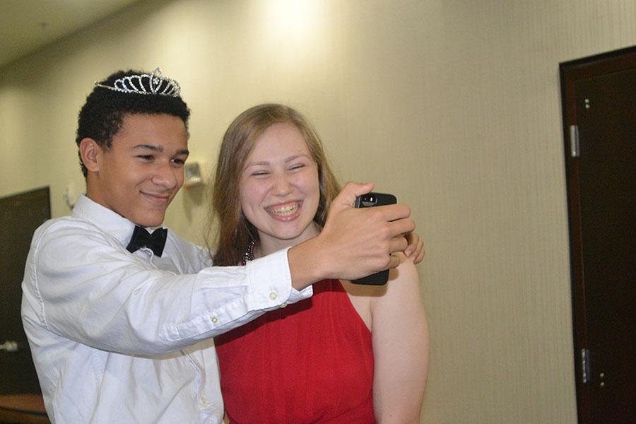 Take a selfie \\ Saber Team Commander Nick Mavis steals a selfie and a crown for a photo op with sophomore princess Ashley Henagin. 
