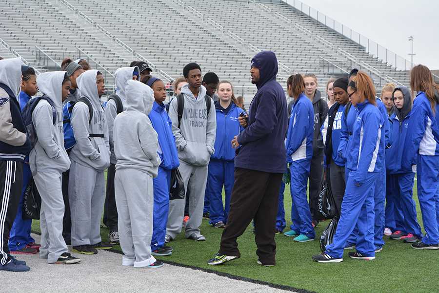 Family first // Giving a motivational speech before their first meet, coach Jason Olford tells the track participants to do their best Feb. 21.