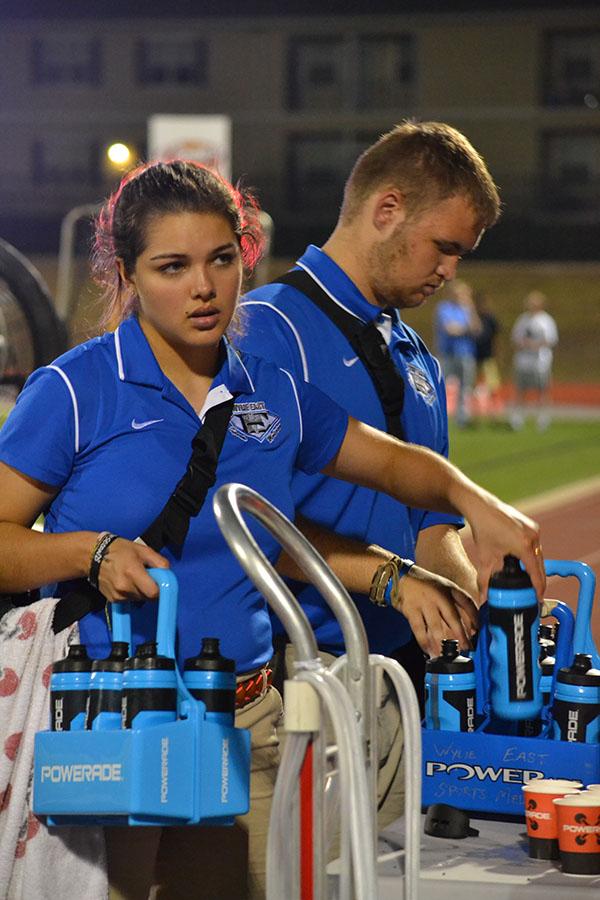 Head in the game \\ Making sure that the players have enough hydration during the game, junior Mikayla Garcia is always moving and working to help the athletes out in any way that she can. “We do a little bit of everything,” Garcia said.