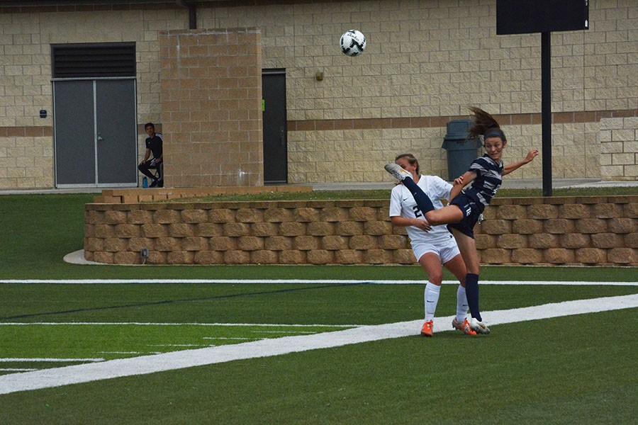 Keeping the ball inbounds, sophomore Addie McCain battles a Grapevine Mustang at the semi finals game in Georgetown April 16. McCain was nominated as the Gatorade player of the UIL. She was also awarded the UIL 5A girls soccer player of the year.