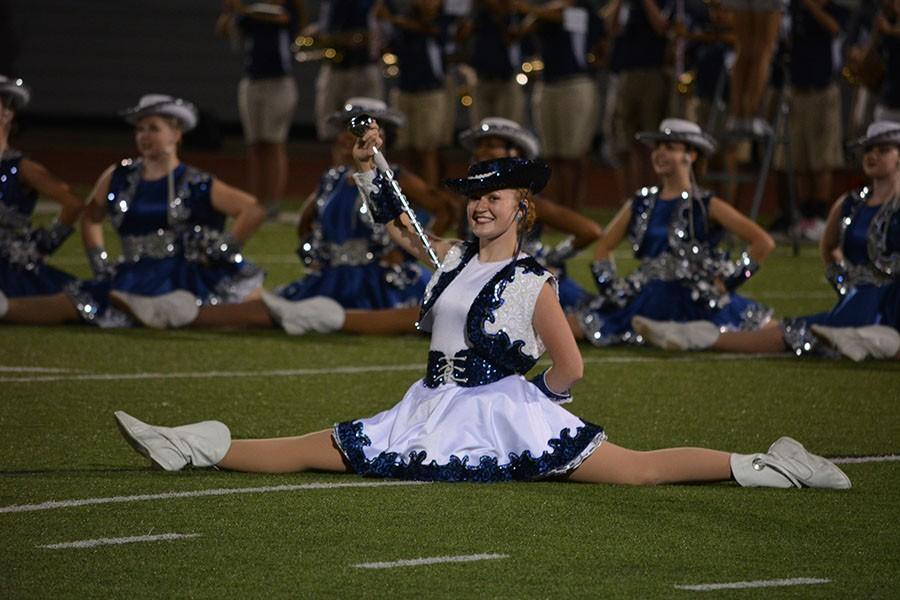 Split second \\ Performing in the middle of the dance against Red Oak Aug. 28, senior Lieutenant Catie Shirley is all smiles in front of the crowd.  