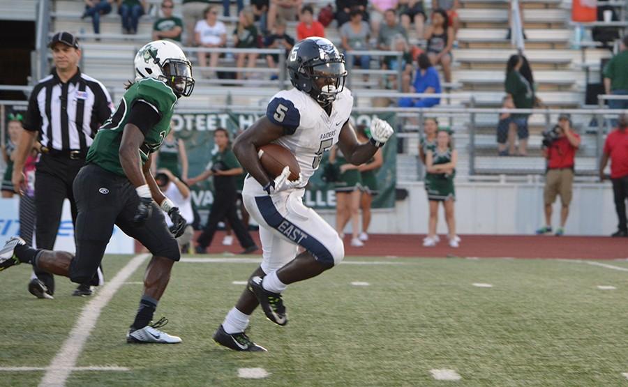 Sports day hero \\ Eno Benjamin, a junior on the varsity football team, runs the ball in for a touch down at the second season game against Mesquite Poteet, Benjamin and four other football players in DFW were nominated the following week to be 