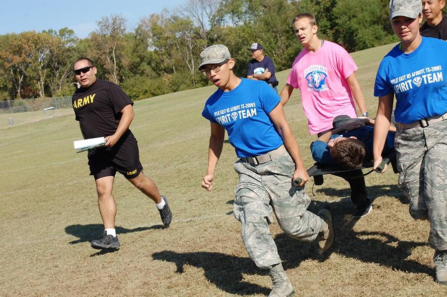 Carry the load \\  Transporting their teammates on a stretcher, JROTC cadets were worked out by U.S. Army recruiters Oct. 16.