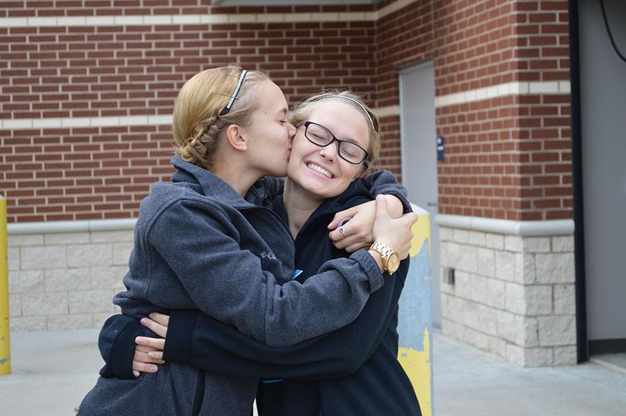 Drum major love \\ Drum majors Greta Williams and Jade Rocha embrace in excitement as they get ready to rehearse before the big show, Williams plants a big kiss on Rocha’s cheek.