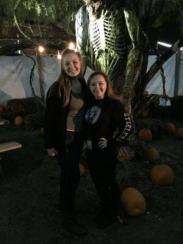 Cute Reporters \\ Staff reporters Kailee Zercher and Caroline May pose for a picture in front of the spooky pterodactyl skeleton at the front entrance of Thrillvania. 