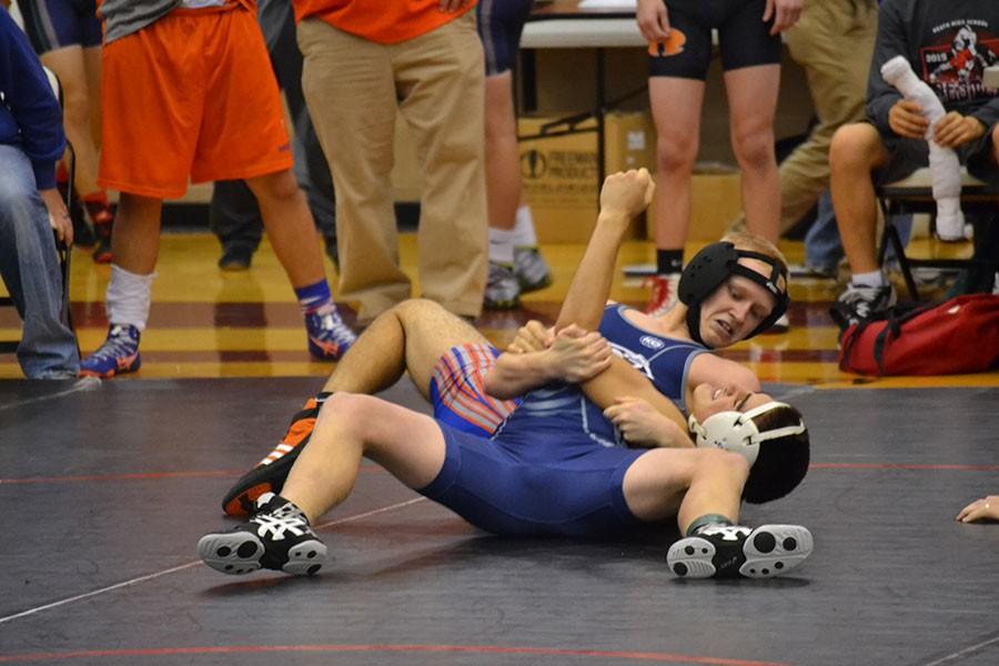 Lil Shady \\ Sophomore Tyler Stephens, aka Lil’ Shady, goes for a pin against his opponent at the Rockwall Heath wrestling invitational. 
