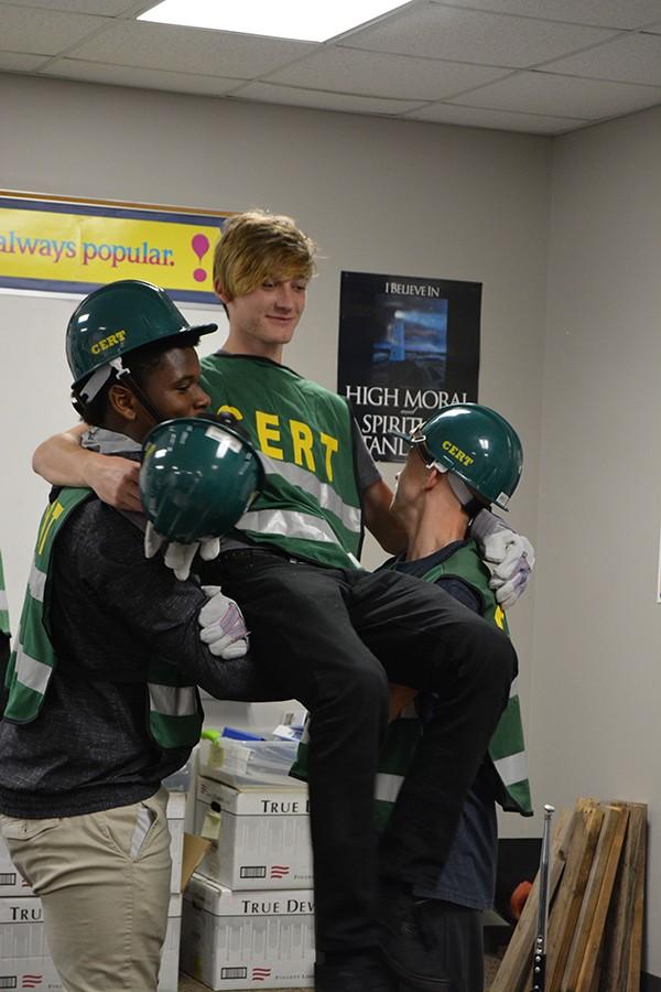 Senior Johnny Sadowski plays a victim while his classmates practice two many rescue carries in law enforcement. Students are studying to take the CERT certification exam.
