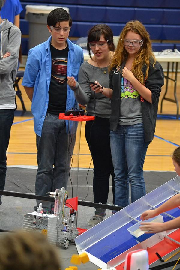 Race+against+time+%5C%5C+Sophomore+Devin+Crabtrey%2C+alumni+Emily+Esch+and+senior+Micah+LaPointe+help+their+team+at+the+robotics+competition+Jan.+16