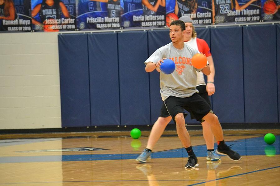 On the ball \\ Senior Jared Wyatt plays dodgeball at the FCA tournament.