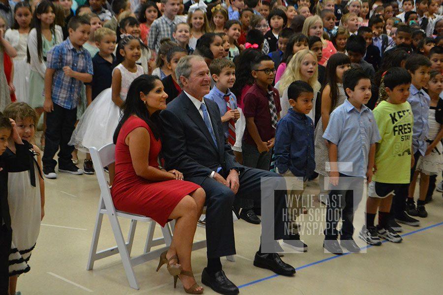 Front and center \\ The principal of the newest Wylie ISD elementary school, Maricela Helm sits with George W. Bush during the presentation of his portrait that will be displayed in the school.