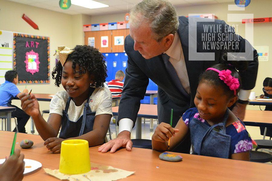 New school \ Former President George W Bush visits with students in an art class prior to his speech Sept. 15 at the dedication of the school in his namesake.