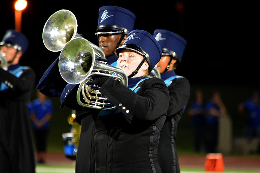 Horns up \\ Junior Ashlyn Stewart, French horn player, marches on Future Raider Night. With three different pieces of music and choreography to learn, the marching band is working to put all 68 sets of drill on the field.  