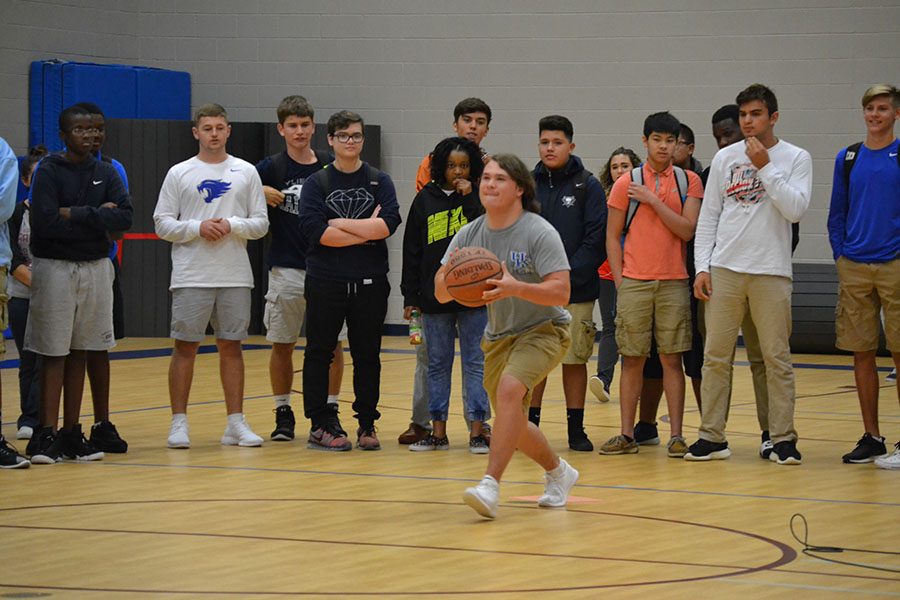 One shot \\ Senior Devin Welty shoots a half-court shot at the FCA kickoff event. Welty wins the $50 prize for being the only one who made the half-court shot.