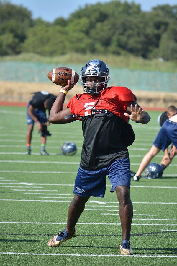 Speed into it \\ Senior Quarterback Eno Benjamin practices after school with the varsity team Sept. 7 before the game against Denton Ryan.