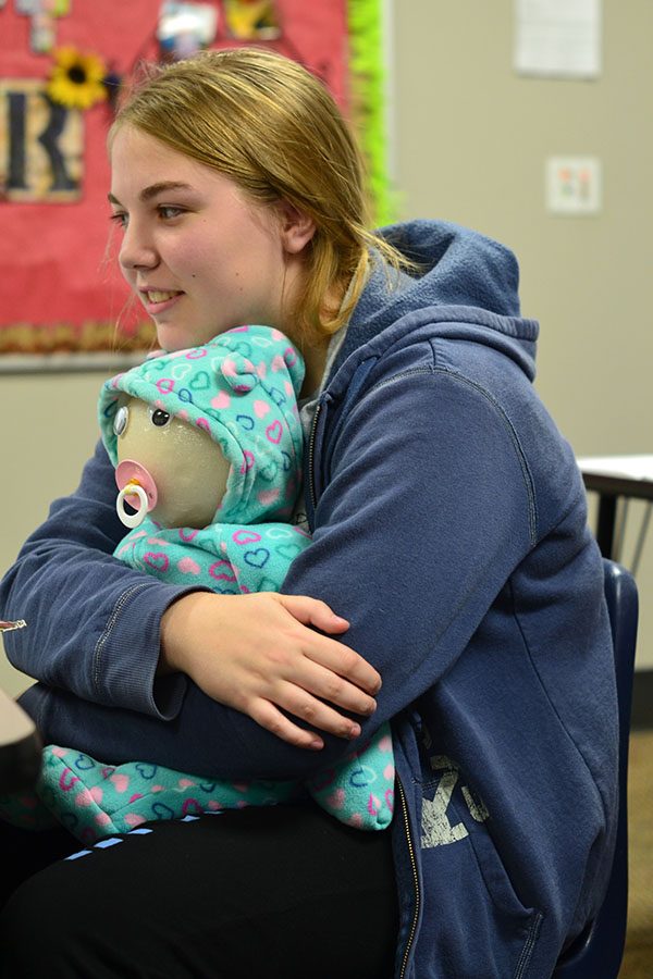 Baby business \\ Sophomore Sarah Porter learns how to care for a baby in Mrs.  DAnna Roseberrys Human Growth and Development class.