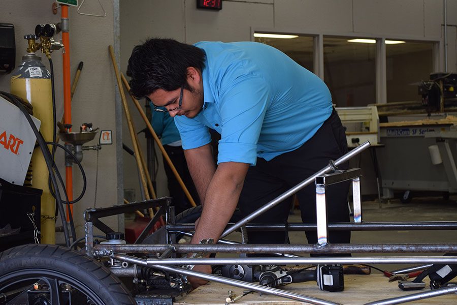 With screw and nail \\ Working on the solar car, junior Rodrigo Garcia is in the process of building the car to race in July at Texas Motor Speedway.