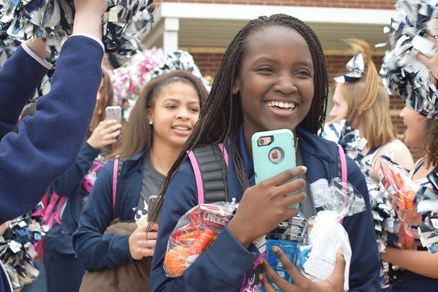 Sending off love \\ Sophomore Mary Nyakundi walks through the cheerleaders spirit line with the varsity basketball team heading out to the game against Texas High in Paris, Texas, Feb. 13 where the girls won 57-43 moving them to the second round of playoffs.