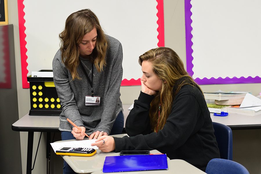 Teachers aid \\ Mrs. Kendal Whisnant helps junior Angela Talley with her assignment in her fifth period Algebra II class.
