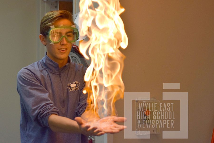 In the palm of his hands  \\ Participating in a chemistry experiment, sophomore Colton Fisher lit bubbles on fire to study certain chemical reactions Dec. 2. 