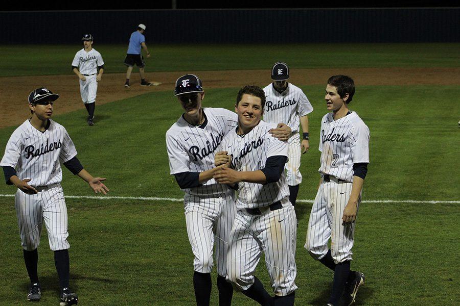 Home run hitter \\ After junior Cooper Andrews slammed a two-run home run, teammates Chris Hattaway and Joshua Wood surround Andrews in celebration against Sachse in the Wylie East Invitational.