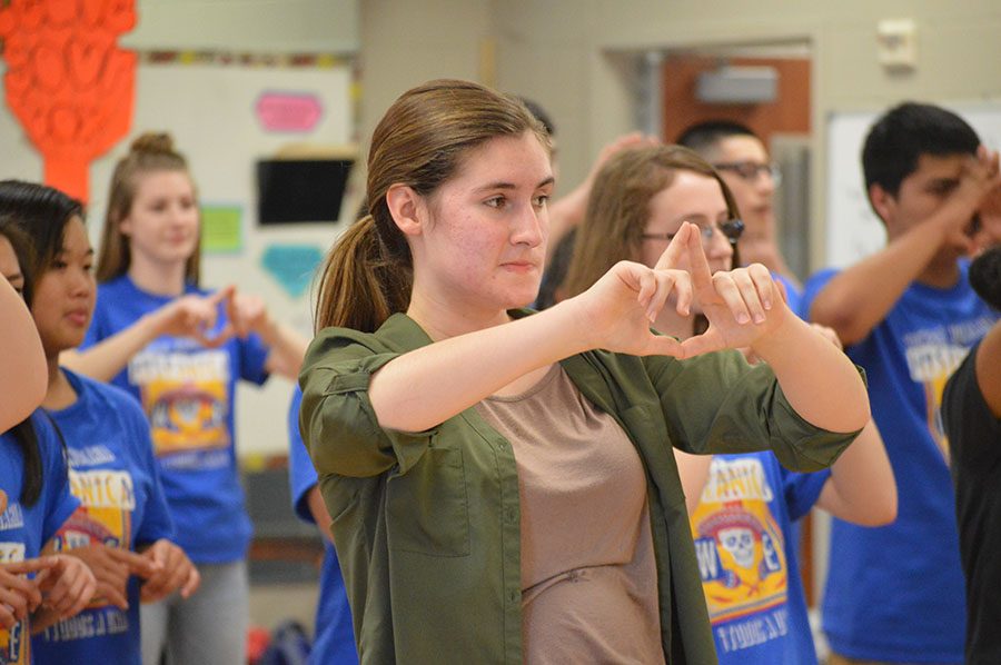 In formation \\ Learning how to dance the salsa, junior Mary Harkins creates a diamond with her hands representing the steps in the Cuban dance. The Spanish Honor Society members met in the dance room March 22 to learn three different Spanish dances: the merengue, bachata, and the salsa.