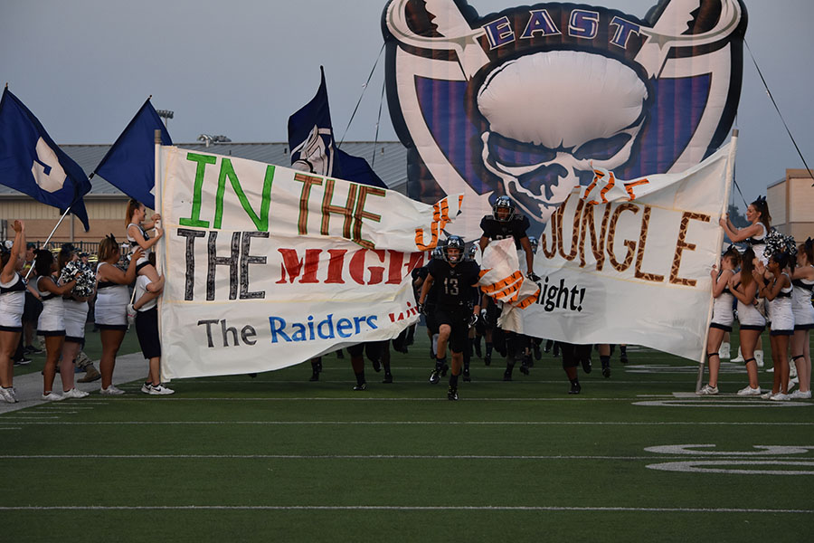 In the jungle // Running onto the field, the varsity football players prepare to play against the Hallsville Bobcats. The Raiders won 28-24 against the Bobcats. 