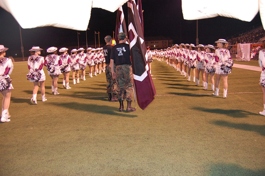 3. Shotgun wedding // JROTC students walk the spirit flags down an aisle of Pacesetters (now the Sapphires). The flags even pronounce the Wylie High lingo “AHMO”.