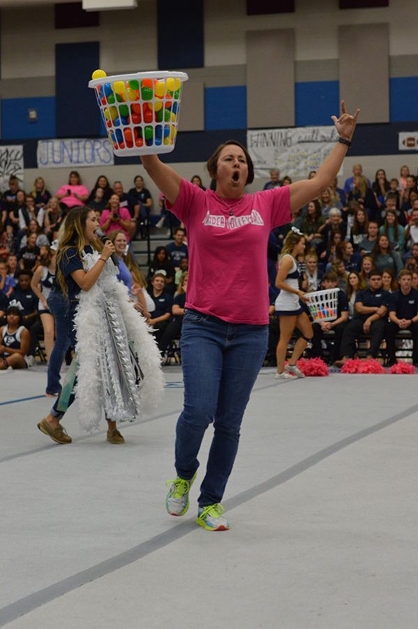 Vicious victory // Taking a victory for her and her teammate Mrs. Samantha  Smith celebrates being victorious in the human Hungry Hungry Hippo game, put on by student council. At every pep rally student council picks students and teachers to partake in games to get the student pumped for that night’s football game. 