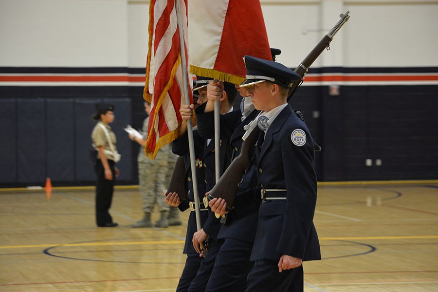 Wheeling around // Completing a right wheel, freshman James “JT” Red listens to Color Guard commander Austin Miller for the next commands at Billy Ryan High School Oct. 14.