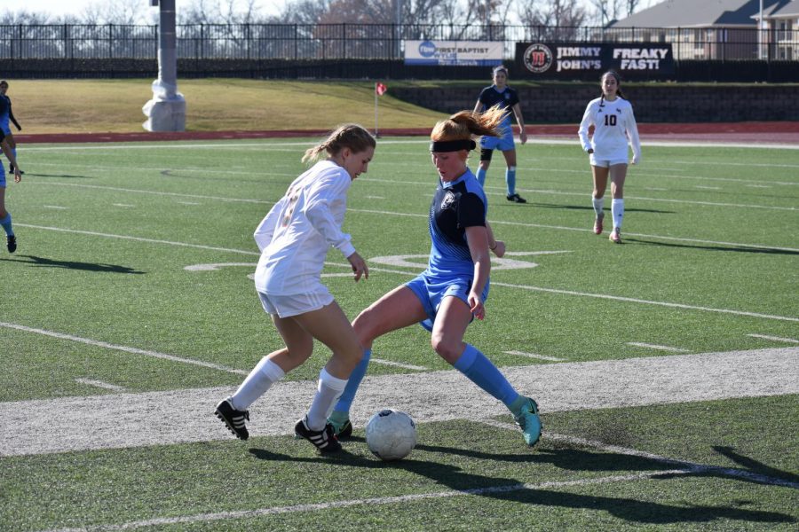 Defeating defender // Stopping a break away, junior Sam Springfield looks to gain possession against a Lake Highlands forward in the final game in the Andie-Studley Memorial showcase. The game ended in a 1-1 tie.