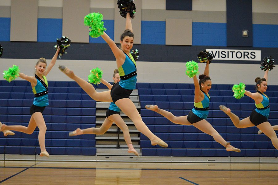 Jump for joy // Doing a raindrop jump, junior Lieutenant Lauren Young performs the competition pom routine. She and her teammates performed their routines at their showoffs Feb. 16 and compete at their first competition Feb. 24 at Duncanville High School. 
