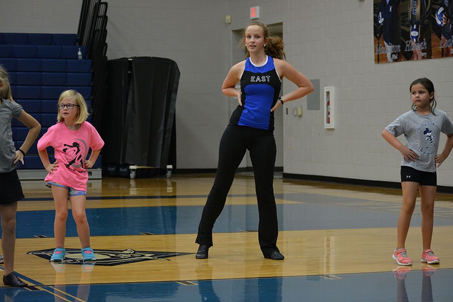 Competition season \\ Freshman Sam Burkart helps out at the annual Junior Jewels clinic. The Sapphires are getting ready for competition this weekend. “The hardest part of competition season is having to wake up early to get to practice and having to get completely ready at school,” Burkart said.