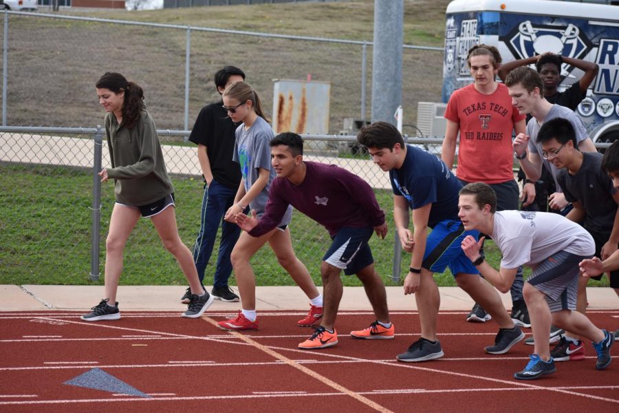 Runner Up \\ Track and cross country runners refine their starts at an after-school practice. The world’s best track and cross country athletes will compete at the 2020 Tokyo summer games.