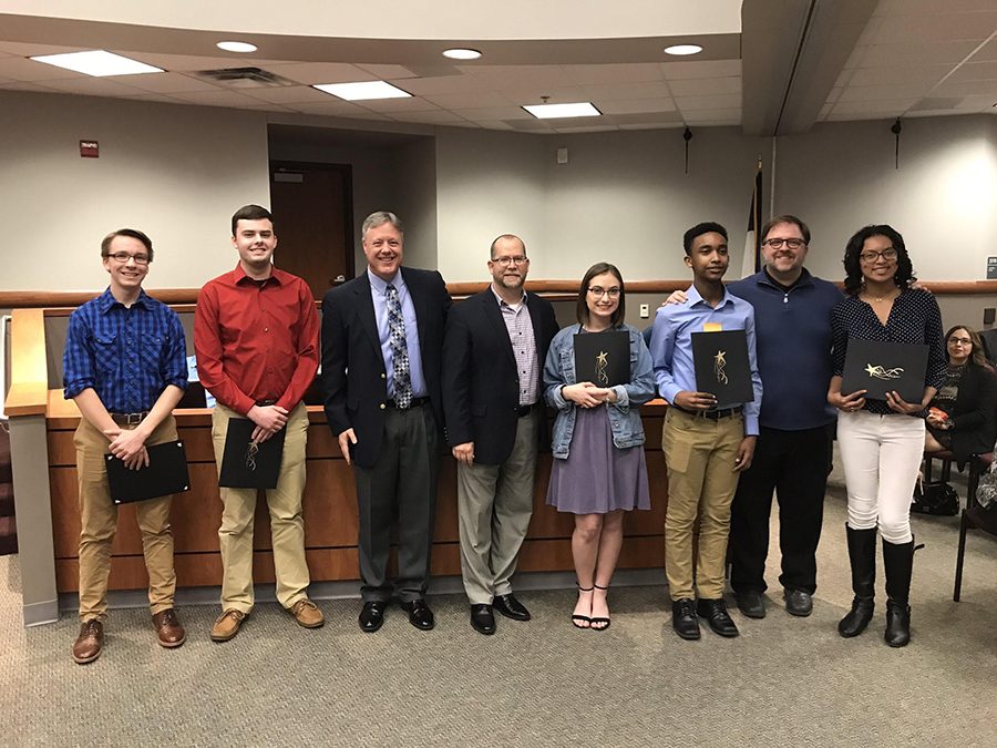 Prestigious players // Posing for the camera, senior Seth Ragsdale stands alongside Director of Bands Gregory Hayes and All-State members from Wylie High and gets recognized for making the All-State band on trumpet for his second year at a school board meeting Feb. 26. photo by Glenn Lambert.