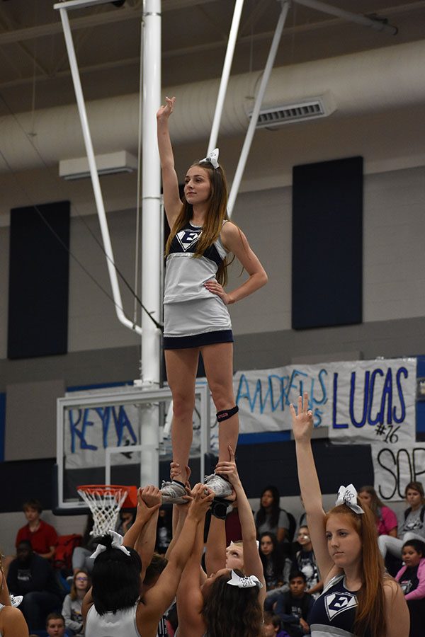 Pep it up // Senior Kyli Ussery performs a cheer routine to a remix of The Hanging Tree for the homecoming pep rally. They chose this song to match the homecoming theme of The Hunger Games.
