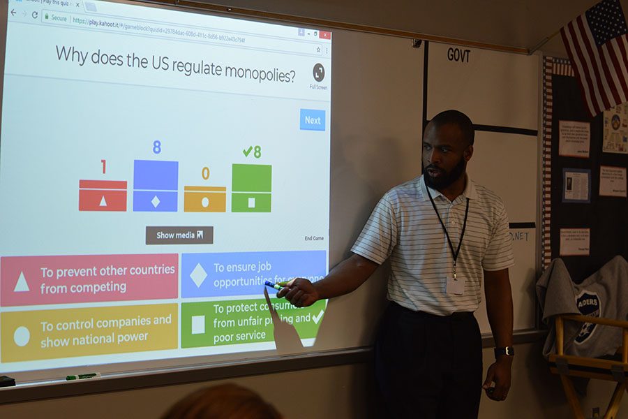 Listen and learn // Reviewing for the upcoming government test, history teacher Mr. Levi Turner goes over the correct answers on the review using Kahoot to engage his students in class Feb. 17 during fourth period. The new teacher who has just joined the WEHS staff is a favorite among students.