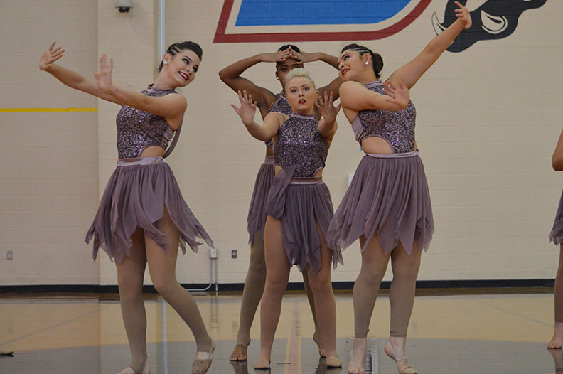 Take center stage // Performing officer contemporary, lieutenants Hannah Mullins, Chahendra Dues, Sarah Armendariz and Captain Brittany Blythe finish their performance at the Duncanville competition Feb. 24. “My favorite part of this dance was how emotional it was. It was at the very end of our dance and the energy was so high and in that moment. Hannah and I would look at each other and feel so accomplished,” Armendariz said.