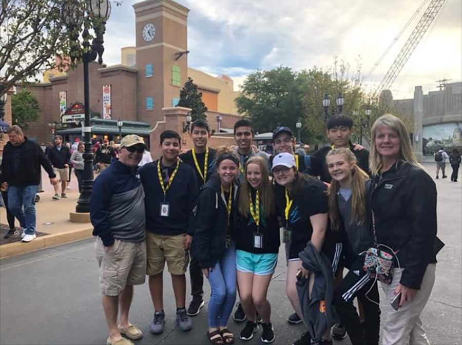 Starstruck students // During the first day in Florida, we went to Disney’s Hollywood Studios. This park filled us with stardom and we even met the star himself, Principal Mike Williams. We snapped a quick photo before riding Star Tours with he and his wife. photo by Myra Williams. 
