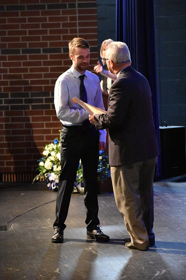 Right on the money // Receiving certificates for AP Physics I, Pre-AP Pre-Calculus, Raiders in Service, Honor Roll and the Assistant Principal’s Award, junior Jaxson Hill shakes Mr. Williams hand before being presented with the Jon Poteat $1,000 scholarship through National Technical Honor Society. Hill was one of 225 national NTHS students selected to earn the scholarship. “I had no idea it was coming, so I was kind of confused when Mrs. Wyatt started announcing it. After she said what it was, I was pleasantly surprised,” Hill said.

