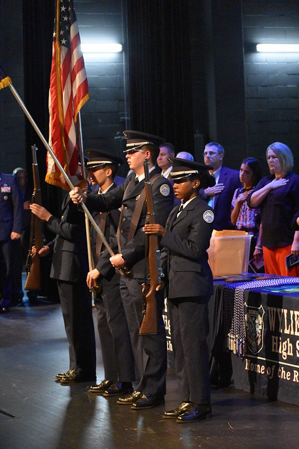 All the colors // Presenting the colors, juniors Austin Miller, Garrett Johnson and freshman Ashanti Hall from the Air Force Junior Reserve Officer Training Corps display the nation’s flags as Choir sings the National Anthem.
